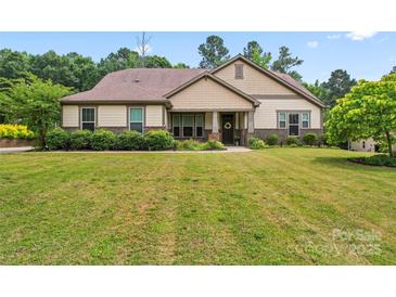 Charming single-Gathering home with a well-manicured lawn and lush landscaping, offering great curb appeal at 137 Leaning Tower Dr, Mooresville, NC 28117