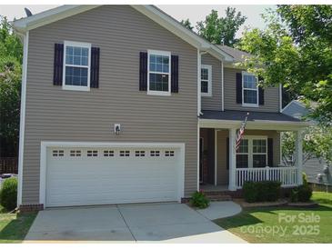 Charming two-story home with a welcoming front porch and well-maintained lawn at 1673 Beleek Ridge Ln, Clover, SC 29710