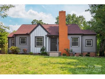Charming home with a red roof, gray siding, orange chimney, and a well-maintained front lawn at 2628 Clydesdale Ter, Charlotte, NC 28208