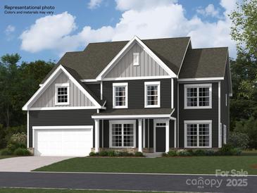 Beautiful two-story home featuring a well-manicured lawn and a two-car garage at 3887 Horsham St, Indian Land, SC 29707