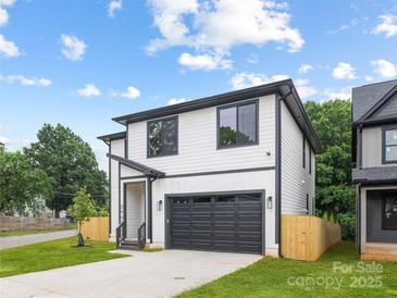Charming two-story home featuring a modern design, black trim and a well-manicured front yard at 3903 Plainview Rd, Charlotte, NC 28208