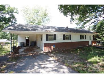 Ranch-style home with carport, brick foundation, and white siding ready for upgrades and personal touches at 402 Villa St, Kannapolis, NC 28083
