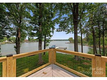 Lake view from the deck with cable railing, wooden posts, and adjacent trees at 5075 Lakeview Cir, Sherrills Ford, NC 28673