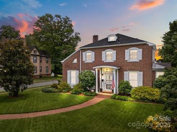Beautiful brick two-story home with manicured lawn, mature trees, and a welcoming brick walkway at 603 S Fulton St, Salisbury, NC 28144