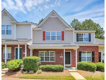 Charming two-story townhome with red brick, red shutters, and manicured landscaping at 10032 Pergola View Ct, Charlotte, NC 28213
