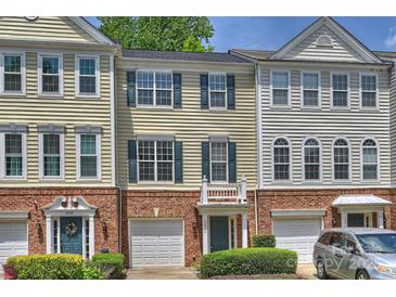 Charming townhome with brick accents, a one car garage and manicured landscaping at 3014 Castleberry Ct, Charlotte, NC 28209
