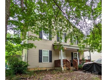 Charming two-story home with a cozy front porch and mature trees at 3241 Reid Ave, Charlotte, NC 28208