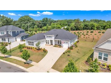 Stunning single story home with well manicured lawn, elegant landscaping, and a long concrete driveway at 513 Meadow Ridge Dr, Belmont, NC 28012