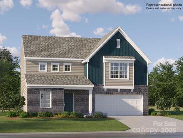 New construction two-story home with brick and siding exterior, two-car garage and professionally landscaped front yard at 521 Millstone Dr, Edgemoor, SC 29712