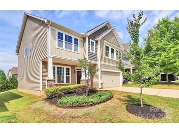 Charming two-story home boasts manicured landscaping and a welcoming entrance at 10004 Perth Moor Rd, Charlotte, NC 28278