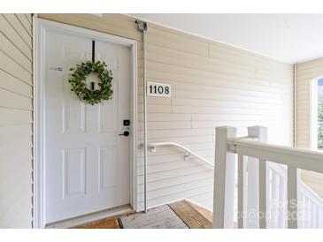 Charming front door with wreath and stylish hardware, creating a welcoming entrance at 1108 Plaza Walk Dr, Charlotte, NC 28215