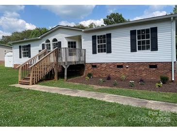Charming home featuring black shutters and a wooden porch in a well-manicured lawn at 1201 Forest Ridge Rd, Bessemer City, NC 28016