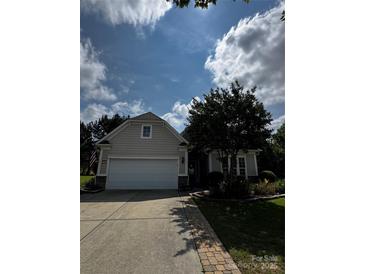 Charming home featuring a two-car garage, manicured landscaping, and a welcoming front walkway at 15116 Legend Oaks Ct, Fort Mill, SC 29707