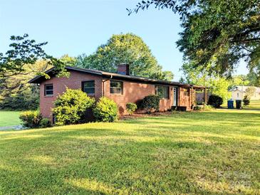 Beautiful brick home with a spacious front yard and mature trees offering shade and curb appeal at 3115 Falling Creek Rd, Hickory, NC 28601