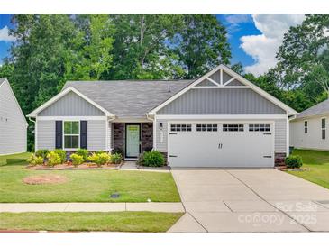 Charming one-story home with grey siding, stone accents, manicured lawn, and a two-car garage at 4511 Hunton Dale Nw Rd, Concord, NC 28027