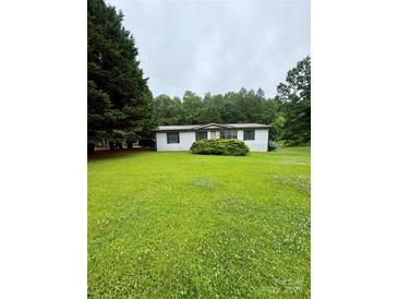 Charming single-story home with fresh green lawn and mature trees at 5022 Wrenn Dr, Denver, NC 28037
