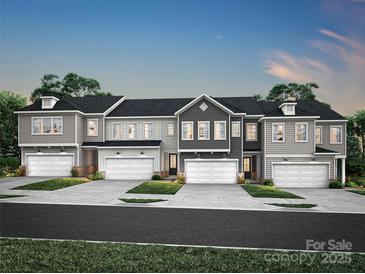 A row of modern townhomes, each featuring a private garage and manicured front lawn, under a twilight sky at 507 Webster Ln, Cramerton, NC 28032