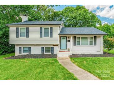 Charming two-story home with white siding, black shutters, and a well-manicured front yard at 1645 Brookdale Ave, Charlotte, NC 28210