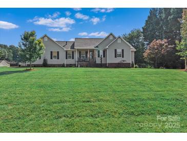 Charming single-story home with a large, well-manicured front lawn and traditional curb appeal at 166 Rumple Hill Dr, Statesville, NC 28677