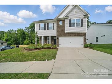 Charming two-story home featuring a brick and siding facade, landscaped front yard, and a two-car garage at 2034 Houle Ln, Charlotte, NC 28214