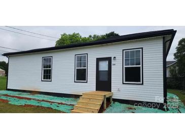 Charming single-story home featuring classic white siding and a welcoming front entrance at 306 E Ratchford Ave, Gastonia, NC 28054