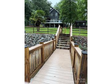 Beautiful waterfront home featuring a private dock and lush landscaping in a serene setting at 315 Wood Duck Loop, Mooresville, NC 28117