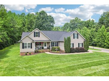 Charming single-story home with manicured lawn, mature trees, and inviting front porch at 320 Bluegill Ln, Statesville, NC 28625