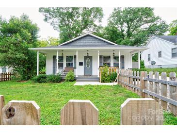 Charming single-story home featuring a covered front porch and a well-maintained front yard with a picket fence at 812 Kings Rd, Shelby, NC 28150