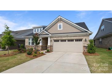 Charming home with a two-car garage, brick facade, manicured lawn, and inviting curb appeal at 9435 Liberty Hill Dr, Mint Hill, NC 28227