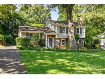 Charming two-story home with a beautifully landscaped front yard and a mix of brick and siding at 4200 Tyndale Ave, Charlotte, NC 28210
