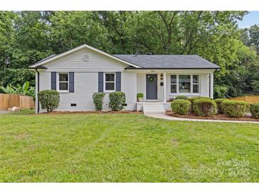 Charming white brick home with a manicured front yard and blue shutters at 7219 Brynhurst Dr, Charlotte, NC 28210