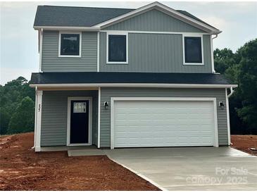 Two story home with gray siding and an attached two car garage and a black door at 823 32Nd Ne St, Conover, NC 28613