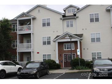 Well-maintained condo building features two stories and a parking lot at 9823 Hyde Glen Ct, Charlotte, NC 28262