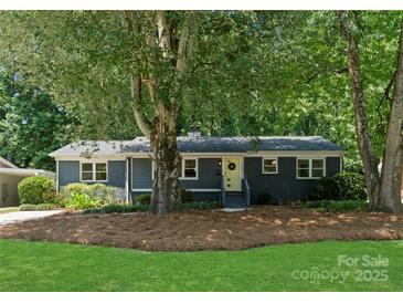 Charming single-story home featuring a freshly painted exterior, landscaped yard, and a welcoming front entrance at 1027 Dresden W Dr, Charlotte, NC 28205