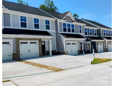 Modern townhome exteriors with attached garages and contemporary design, showcasing curb appeal and convenient parking at 1598 Respect St, Concord, NC 28027