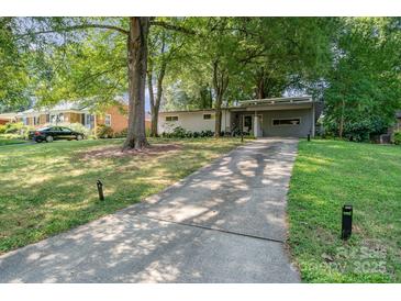 Charming single-story home with mature trees, a long driveway, and a carport at 5742 Murrayhill Rd, Charlotte, NC 28210