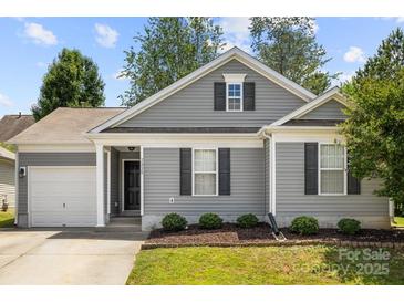 Charming one-story home features gray siding, black shutters, and a well-manicured lawn at 7315 Gasper Ln, Fort Mill, SC 29707
