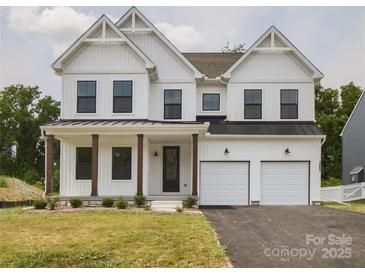 Stunning two-story home with a two-car garage, covered porch, and stylish curb appeal at 236 Paradise Dr, Belmont, NC 28012