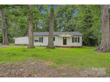 Charming home with white siding, black shutters, mature trees, and a well-maintained lawn at 240 Swink Ave, Salisbury, NC 28147