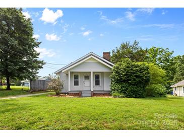 Charming single-story home featuring a landscaped lawn, covered front porch, and classic architectural details at 2519 2Nd Sw Ave, Hickory, NC 28602