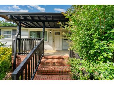 Inviting front entrance with brick steps, dark railing, and a covered porch area at 307 Elm St, Belmont, NC 28012