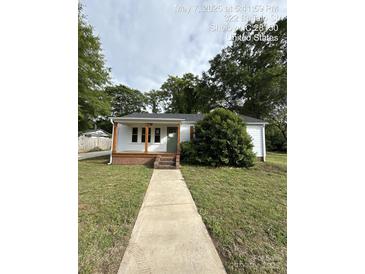 Charming single-story home features a tidy front yard, a welcoming porch, and a classic white exterior at 322 Buffalo St, Shelby, NC 28150