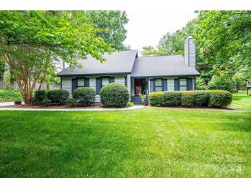 Charming single-Gathering home featuring lush landscaping and a well-manicured lawn at 3221 5Th Street Nw Ct, Hickory, NC 28601