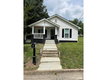 Charming home with classic details, a welcoming front porch, and a well-manicured lawn at 512 S Gray St, Gastonia, NC 28052