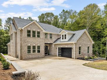 Magnificent two-story brick home featuring a spacious driveway and an attached two-car garage at 5217 Waterfall Ct, Gastonia, NC 28056