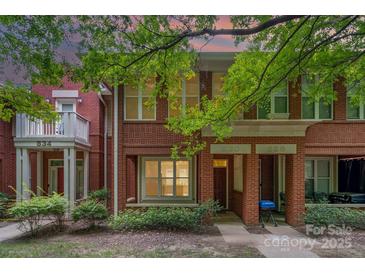 Charming red brick townhomes with inviting front porches and lush, mature landscaping at 530 E 9Th St, Charlotte, NC 28202