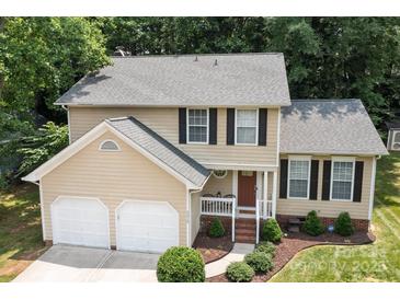 Charming two-story home features a manicured lawn, a two-car garage, and a welcoming front porch at 7212 Morsey Ct, Charlotte, NC 28269