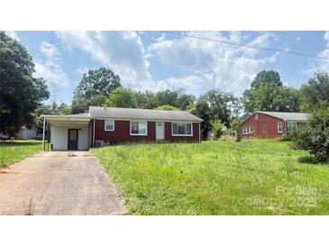 Charming single-story brick home with a carport and a spacious front yard at 1073 Springdale Dr, Maiden, NC 28650