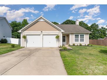 Charming single-story home featuring an attached two-car garage and well-maintained front lawn at 12829 Brandenburg Ln, Midland, NC 28107