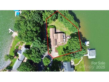 Aerial view of the lake house, including the house and the surrounding trees and lake at 160 Quail Hollow Dr, Kings Mountain, NC 28086